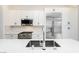 Close up of modern kitchen with stainless steel appliances, quartz countertop, and sleek fixtures at 901 Allister Fields Ln, Las Vegas, NV 89138