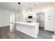 Modern kitchen featuring a large island, stainless steel appliances, and sleek white cabinetry at 901 Allister Fields Ln, Las Vegas, NV 89138