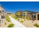 A modern home exterior featuring drought-tolerant landscaping and a fenced-in patio at 901 Allister Fields Ln, Las Vegas, NV 89138