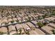 Expansive aerial view of a densely populated neighborhood showcasing homes with desert landscaping at 9017 Iron Hitch Ave, Las Vegas, NV 89143