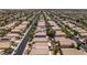 An aerial view shows a dense residential neighborhood with uniform houses and organized street layout at 9017 Iron Hitch Ave, Las Vegas, NV 89143