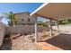 Landscaped backyard with a covered patio and desert style gardens at 9017 Iron Hitch Ave, Las Vegas, NV 89143
