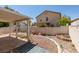 Cozy backyard featuring a covered patio, gravel landscaping, and a charming garden bed at 9017 Iron Hitch Ave, Las Vegas, NV 89143