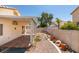 Relaxing backyard with a covered patio, desert landscaping, and privacy fencing at 9017 Iron Hitch Ave, Las Vegas, NV 89143