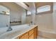Bathroom with double sinks, large mirror, and tub-shower combination at 9017 Iron Hitch Ave, Las Vegas, NV 89143