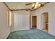 Bedroom with green carpet, ceiling fan, and mirrored closet doors at 9017 Iron Hitch Ave, Las Vegas, NV 89143