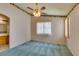 Bedroom has green carpet, ceiling fan, and large window with vertical blinds at 9017 Iron Hitch Ave, Las Vegas, NV 89143