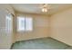 Bedroom with green carpet, ceiling fan, and double door closet at 9017 Iron Hitch Ave, Las Vegas, NV 89143