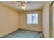 Standard bedroom with green carpet, ceiling fan, and window at 9017 Iron Hitch Ave, Las Vegas, NV 89143