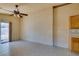 Cozy dining space with a ceiling fan, tile flooring, and sliding glass doors opening to the backyard at 9017 Iron Hitch Ave, Las Vegas, NV 89143