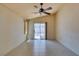 Bright dining room with tile floors, a modern ceiling fan, and slider doors to a covered patio at 9017 Iron Hitch Ave, Las Vegas, NV 89143