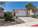 Charming one-story home with a two-car garage and low-maintenance desert landscaping at 9017 Iron Hitch Ave, Las Vegas, NV 89143