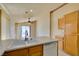 Bright kitchen with oak cabinets and a view into the dining and patio area at 9017 Iron Hitch Ave, Las Vegas, NV 89143