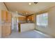 Bright kitchen with tile floors, neutral countertops, and wood cabinets at 9017 Iron Hitch Ave, Las Vegas, NV 89143