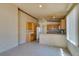 Open kitchen and living room area with tile floors and neutral color scheme at 9017 Iron Hitch Ave, Las Vegas, NV 89143