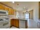 Functional kitchen featuring white appliances and oak cabinets for a classic look and feel at 9017 Iron Hitch Ave, Las Vegas, NV 89143