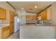 Bright kitchen with tile floors, neutral countertops, and wood cabinets at 9017 Iron Hitch Ave, Las Vegas, NV 89143