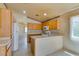 Bright kitchen with tile floors, neutral countertops, and wood cabinets at 9017 Iron Hitch Ave, Las Vegas, NV 89143