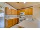 Bright kitchen with tile floors, neutral countertops, wood cabinets and stainless appliances at 9017 Iron Hitch Ave, Las Vegas, NV 89143