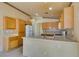 Bright kitchen with tile floors, neutral countertops, and wood cabinets at 9017 Iron Hitch Ave, Las Vegas, NV 89143