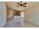 Bright living room and kitchen area with tile flooring and a ceiling fan at 9017 Iron Hitch Ave, Las Vegas, NV 89143