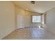 Bright living room with tile flooring, neutral walls, and natural light from windows at 9017 Iron Hitch Ave, Las Vegas, NV 89143