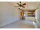 Bright living room and kitchen area with tile flooring and a ceiling fan at 9017 Iron Hitch Ave, Las Vegas, NV 89143