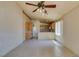 Bright living room and kitchen area with tile flooring and a ceiling fan at 9017 Iron Hitch Ave, Las Vegas, NV 89143