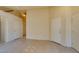 Bright living room featuring neutral tile flooring and white doors leading to other rooms at 9017 Iron Hitch Ave, Las Vegas, NV 89143