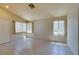 Bright living room with tile flooring, neutral walls, and natural light from windows at 9017 Iron Hitch Ave, Las Vegas, NV 89143