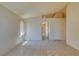 Sunlit living space boasting tile flooring, adjacent to an archway leading to the kitchen area at 9017 Iron Hitch Ave, Las Vegas, NV 89143