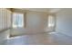 Bright living room featuring tile flooring, neutral walls, and natural light from the windows at 9017 Iron Hitch Ave, Las Vegas, NV 89143