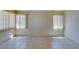 Bright living room featuring tile flooring, neutral walls, and natural light from the windows at 9017 Iron Hitch Ave, Las Vegas, NV 89143
