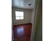 Cozy bedroom featuring wood floors and a window offering natural light at 994 River Walk Ct, Henderson, NV 89015