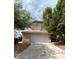 Charming home with a two-car garage, desert landscaping, and a red tile roof at 994 River Walk Ct, Henderson, NV 89015