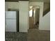 A kitchen area with white cabinets, a granite countertop and stainless steel refrigerator at 994 River Walk Ct, Henderson, NV 89015