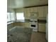 Bright kitchen featuring granite countertops, tile flooring and white appliances at 994 River Walk Ct, Henderson, NV 89015