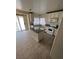 Bright kitchen features an island with granite countertop, tile floor, and stainless steel appliances at 994 River Walk Ct, Henderson, NV 89015