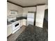 Well-lit kitchen with white cabinets, a central island, and essential appliances at 994 River Walk Ct, Henderson, NV 89015