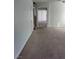 Spacious living room with carpeted floor and view to the entry way and stairs at 994 River Walk Ct, Henderson, NV 89015