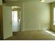 Living room features neutral carpet and paint and a view to the other spaces in the home at 994 River Walk Ct, Henderson, NV 89015