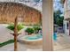 Lush backyard features a pool, tiki umbrellas, and a built-in spa at 10829 Ickworth Ct, Las Vegas, NV 89135