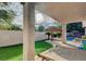 Relaxing backyard with patio, hammocks, lush greenery, and resort-style lounge at 10829 Ickworth Ct, Las Vegas, NV 89135
