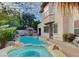 Beautiful backyard with a swimming pool, a spa, and mature trees, perfect for outdoor relaxation at 10829 Ickworth Ct, Las Vegas, NV 89135