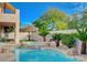 Luxurious backyard with a pristine pool, a spa, and a covered patio area for lounging and entertaining at 10829 Ickworth Ct, Las Vegas, NV 89135