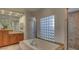 Relaxing bath with a glass block window and a luxurious soaking tub at 10829 Ickworth Ct, Las Vegas, NV 89135