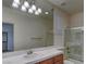Bathroom featuring a large mirror, vanity, and shower with sliding doors at 10829 Ickworth Ct, Las Vegas, NV 89135
