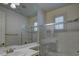 Bright bathroom features an enclosed walk-in shower, large mirror and ample lighting at 10829 Ickworth Ct, Las Vegas, NV 89135