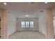 Bright, expansive room featuring neutral carpeting and large windows for natural lighting at 10829 Ickworth Ct, Las Vegas, NV 89135