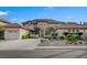 Elegant two-story home boasting a circular entry, lush landscaping, and an attached three-car garage at 10829 Ickworth Ct, Las Vegas, NV 89135